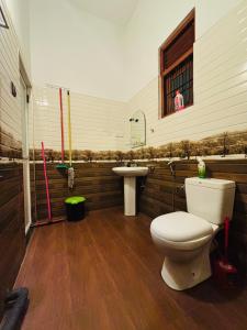 a bathroom with a toilet and a sink at The Pearl Heaven in Dickwella