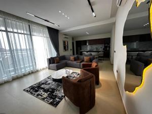 a living room with a couch and a table at SIO APARTMENTs in Lekki
