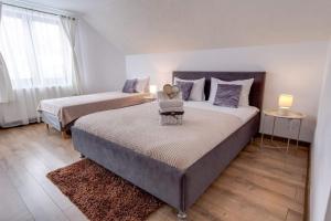 a bedroom with two beds and a table with a chair at Oana Boutique C D I in Bran +47 photos