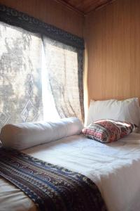 Ένα ή περισσότερα κρεβάτια σε δωμάτιο στο Bản Sù