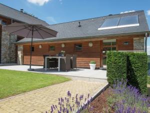a patio with a table and an umbrella at Luxury Apartment in Malmedy with bubble bath in Malmedy