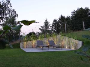 two chairs and a table in a yard at Luxury Apartment in Malmedy with bubble bath in Malmedy