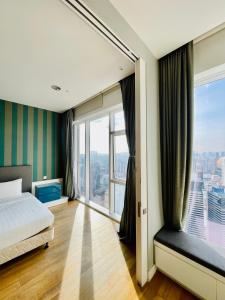 a bedroom with a bed and a large window at Platinum Grand Stay Kuala Lumpur in Kuala Lumpur +58 photos