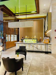 a lobby of a restaurant with a counter and chairs at Platinum Grand Stay Kuala Lumpur in Kuala Lumpur