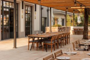 a dining room with a long table and chairs at Centrale Lustica Bay by Angsana in Radovići