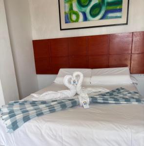 Ένα ή περισσότερα κρεβάτια σε δωμάτιο στο Hotel Las Cabañas de Bonanza +51 φωτογραφίες