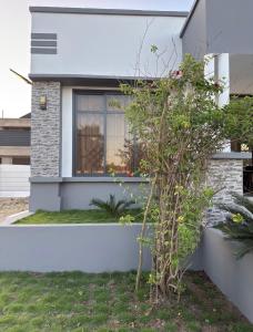 a house with a small tree in front of it at SC Luxury Home in Dar es Salaam