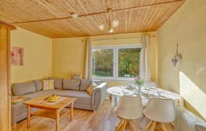 a living room with a table and a couch at Ferienhaus Boitzenburger Land in Rosenow
