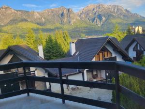 a balcony with a view of a mountain at Zafra Chalet in Poiana Ţapului