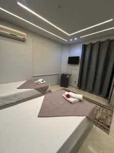 a room with two beds and a tv in it at Garden City Hotel In Downtown in Cairo