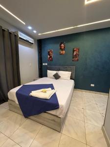 a bedroom with a bed with a blue wall at Garden City Hotel In Downtown in Cairo +8 photos