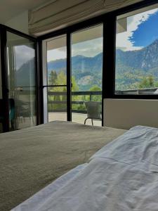 a bedroom with a bed with a view of the mountains at Zafra Chalet in Poiana Ţapului +17 photos