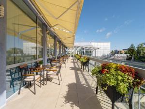 a patio with tables and chairs and plants on a building at Clarion Congress Hotel Ostrava in Ostrava