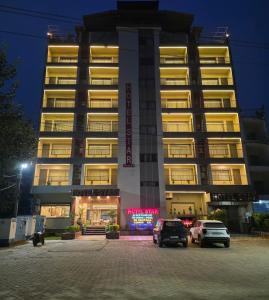 a building with cars parked in front of it at night at Hotel Star Bodh Gaya in Bodh Gaya