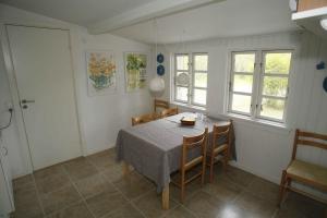 a dining room with a table and chairs at Child-Friendly Holiday 500 Meters From The Beach in Nykøbing Sjælland