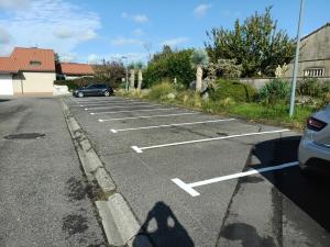 a car is parked in a parking lot at Chambre privée chez l'habitant - La Chambre Framboise in Colomiers