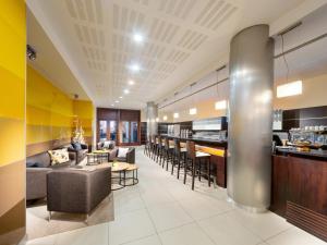 a lobby of a hotel with a bar and chairs at Clarion Congress Hotel Ostrava in Ostrava