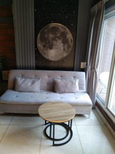 a living room with a couch and a table at Rustic Roots Inn in Jāmb
