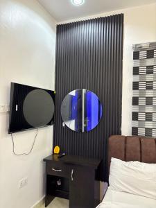 a mirror on a wall next to a bed at Hideout in Ankuru