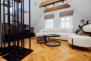 a living room with a white couch and a table at Grodzka Stare Miasto Aparthotel - Dream Apart in Jelenia Góra