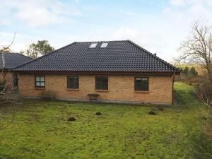 a house with a roof on top of a yard at Luxury Fjordview Retreat-By Traum in Højslev +81 photos