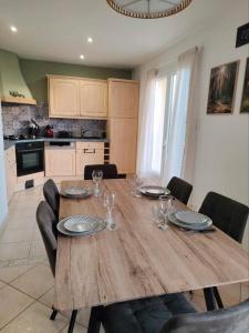 a wooden table in a kitchen with a dining room at Gîte De L 'entre 2 Côtes in Vindefontaine