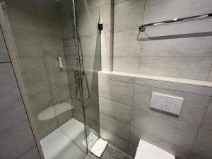 a bathroom with a shower with a glass door at Hotel Drei Könige in Chur +65 photos