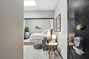 a bedroom with a bed and a room with a table at New Listing The 483 Suite - Walk to Stadium in Athens +2 photos