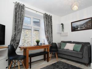 a living room with a couch and a table at Wanderers Rest in Lynton