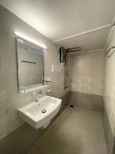 a bathroom with a white sink and a mirror at Dambulla Village Stay in Dambulla