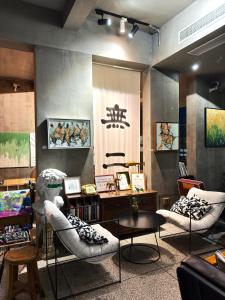 a room with two chairs and a table in a store at Suzhou Unique Space Design Art Hotel in Suzhou