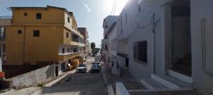 a city street with cars parked on the side of buildings at Studio SARAH in Tabarka
