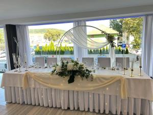 a wedding table with a white table cloth and flowers at Hotel Alibaba in Humenné +70 photos