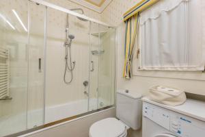 a bathroom with a shower and a toilet at City Center Suite - In the elegant heart of Lecco in Lecco