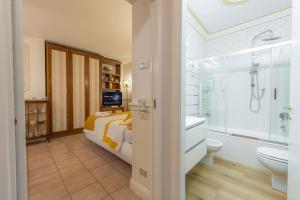 a bathroom with a bed and a tub and a sink at City Center Suite - In the elegant heart of Lecco in Lecco