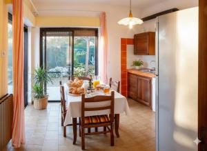 a kitchen and dining room with a table and chairs at Da Ernestina in Imperia