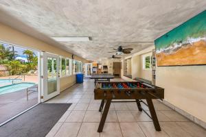 a room with a pool table and a painting on the wall at Maui Kai 808 · MK 808 OceanFront 1BD Kaanapali Beach Ocean Views in Lahaina