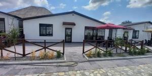 a house with a patio and an umbrella at Ağ Evlər in Cülyan