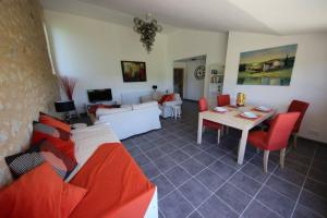 a living room with a couch and a table at Liguand Gites in Saint-Quentin-du-Dropt