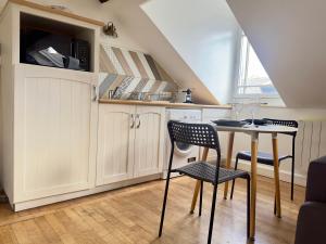 a kitchen with a table and chairs in a room at Duplex Beauvoisine in Rouen +7 photos
