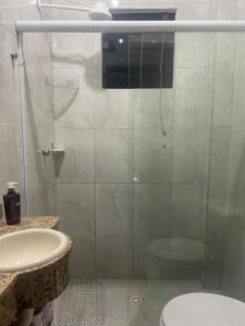 a bathroom with a shower with a toilet and a sink at Casa Mar in Guaratuba +5 photos