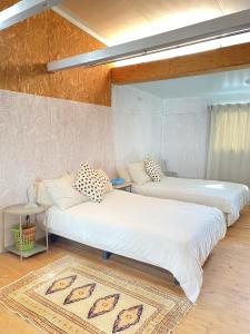 two beds in a room with a rug at Takoyaki Time Osaka in Osaka +9 photos