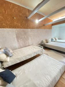 a room with two beds and a mirror at Takoyaki Time Osaka in Osaka