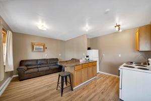 a kitchen and living room with a couch and a table at Badlands Hotel & Campground in Interior +25 photos