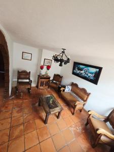 a living room with couches and a table at Aparta Hotel El Refugio de María in Villa de Leyva
