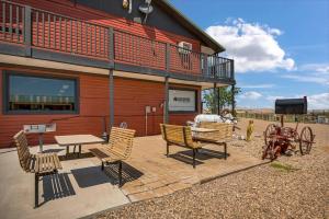 a group of chairs and tables outside of a building at Badlands Hotel & Campground in Interior