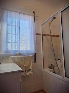 a bathroom with a shower and a sink at Porto Martins Bay Apartments AL in Porto Martins +67 photos