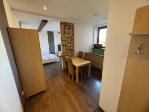 a room with a table and a room with a pool at Willa Aniołówka in Kościelisko