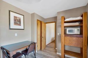 a small room with a desk and a microwave at Badlands Hotel & Campground in Interior