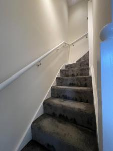 a staircase in a house with concrete steps at Walk to Addenbrookes - Stylish 1 bed Apartment in CBG